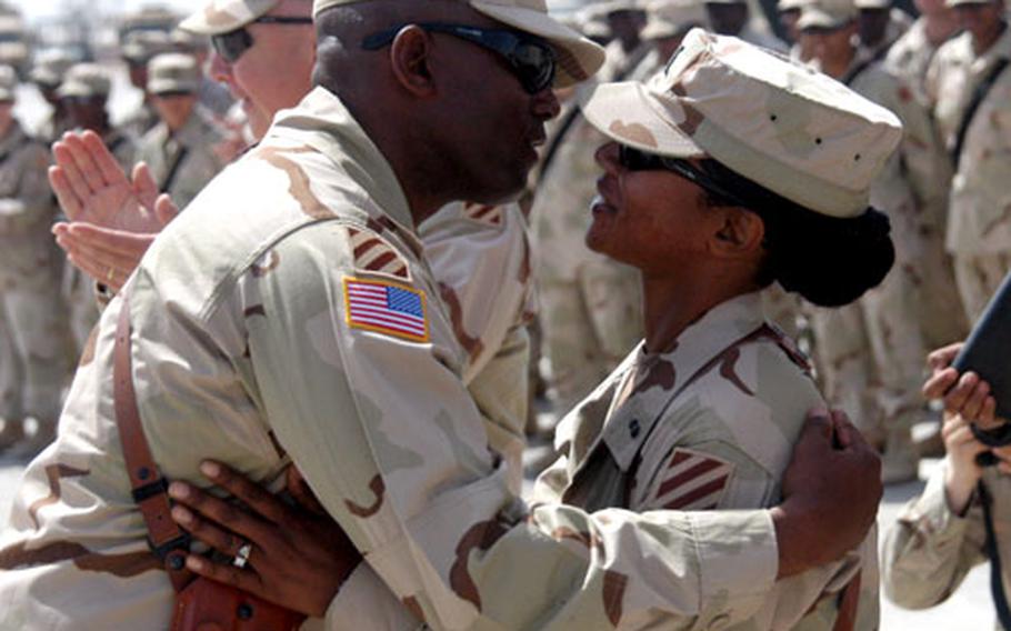 Chief Warrant Officer 3 Sezandra Y. Pinckney of Company B, 603rd Aviation Support Battalion, Aviation Brigade gets a kiss from her husband, Sgt. Maj. Allen Pinckney Sr., 40, the 3rd Infantry Division’s operations sergeant major, following her recent promotion during a ceremony at Camp Taji, Iraq.
