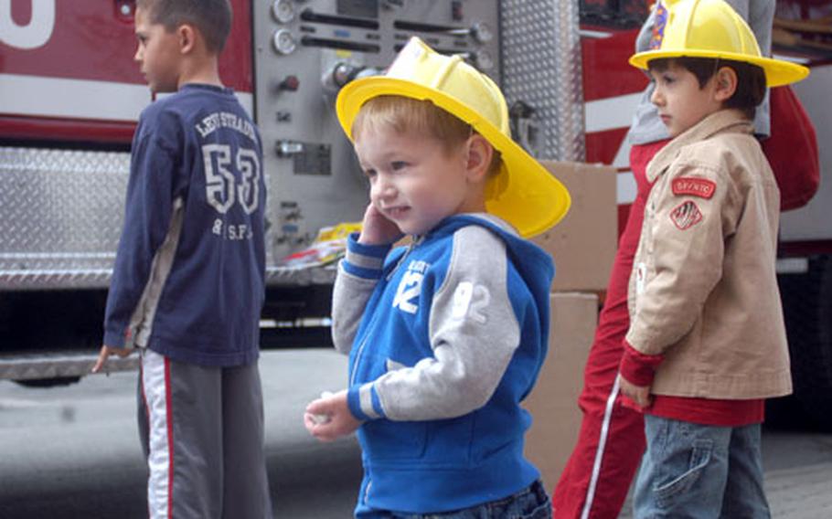 From left, Logan Kinn, 3, and Antonio Abi-Nader, 4, learn about fire safety Thursday at the Darmstadt, Germany, Child Safety, Health, and Fitness fest.