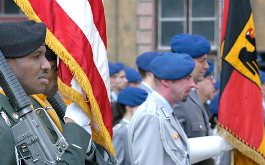 Staff Sgt. Broderick Allen from Company B, 7th Army Training Command, left, stands with the American color guard next to a group of German soldiers at a ceremony commemorating the 60th anniversary of the battle for Weissenfels at the end of World War II.