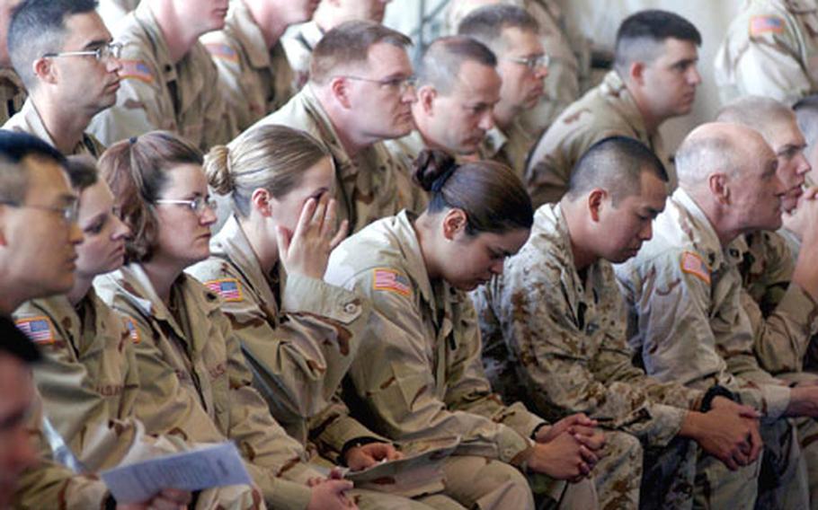 A mourner wipes away a tear during Friday&#39;s memorial service at Bagram.