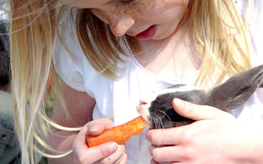 Cayli Rich, 6, cuddles a rabbit outside the Naval Air Facility Atsugi, Japan, Child Development Center on Friday.