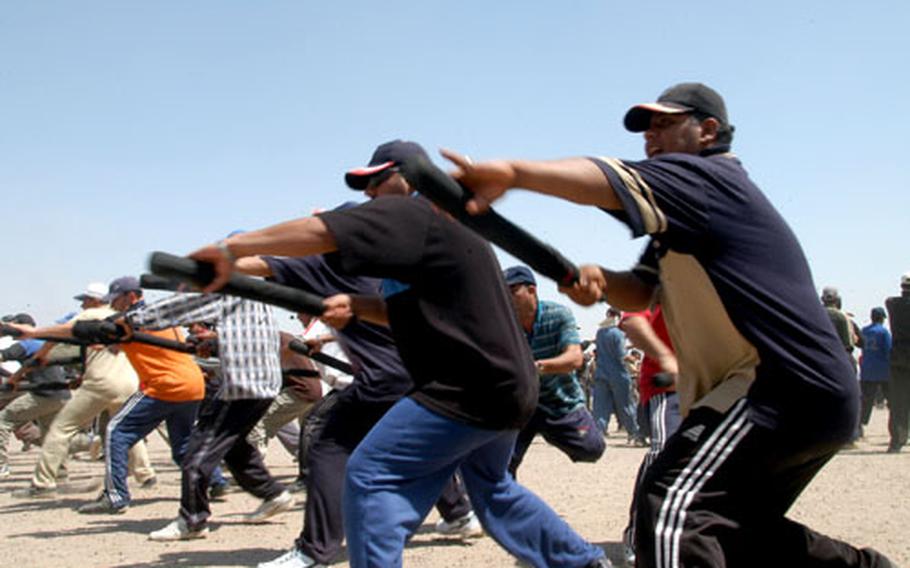 Cadets at the Baghdad Police Academy train to use their batons. The cadets are enrolled in an eight-week training program that teaches them the basics of policing.
