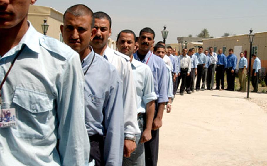 Cadets at the Babylon Police Academy in Hilla, Iraq, wait in line to enter the dining facility for lunch. The students do everything as a platoon, from training to dining. The academy is the first of five training centers to use only Iraqi instructors.