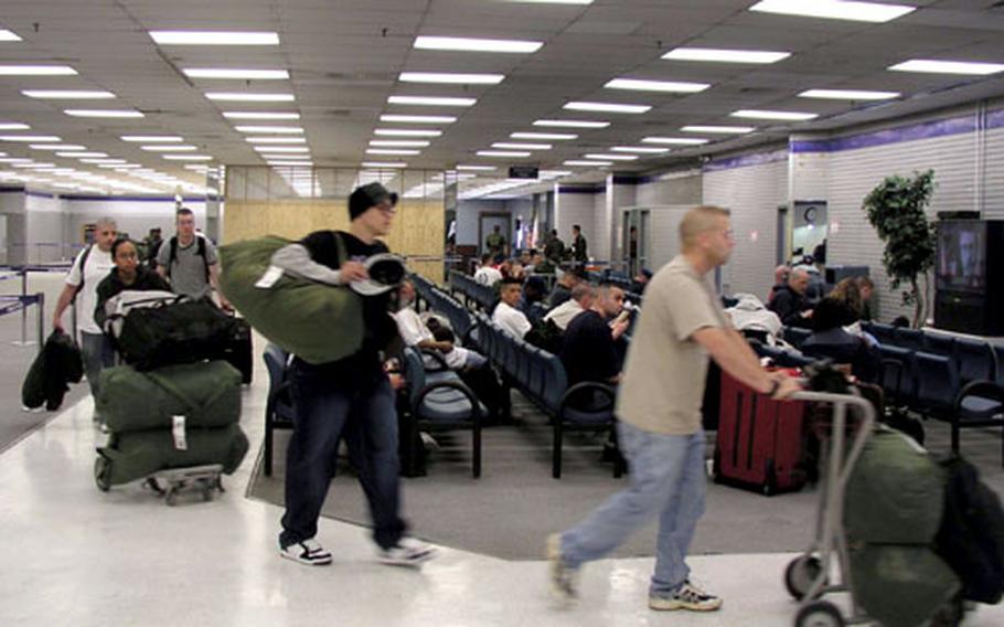 Servicemembers newly arrived for duty in South Korea make their way through the interim passenger terminal at Osan Air Base Thursday. Base officials recently took the vacant former base exchange building and transformed it into a bustling passenger terminal.