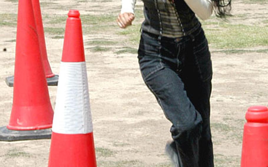 Zahrr Alganabe runs between cones during an obstacle course test given to candidates seeking to join the Iraqi Police.