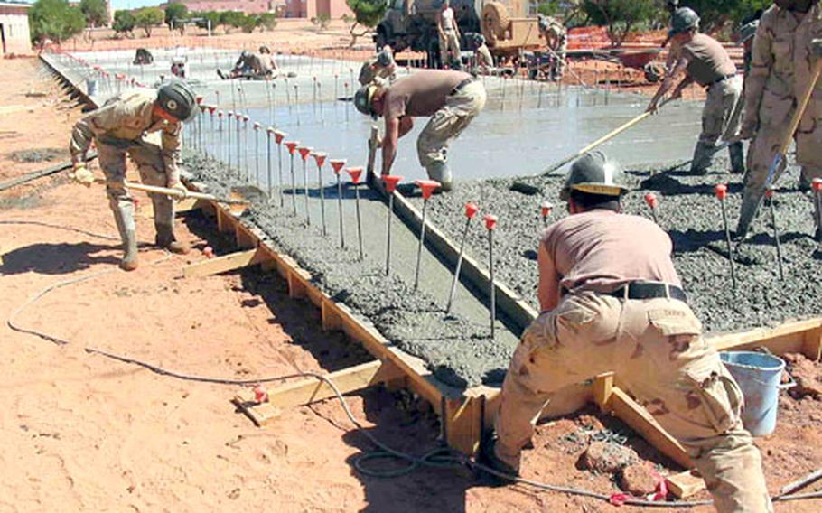 Seabees pour concrete during one of Naval Mobile Construction Battalion 1’s projects during the African Lion 2005 engineering exercise. Approximately 50 Seabees from the Gulfport, Miss.-based battalion are taking part in the bilateral exercise in Morocco for three months with engineering forces from that country.