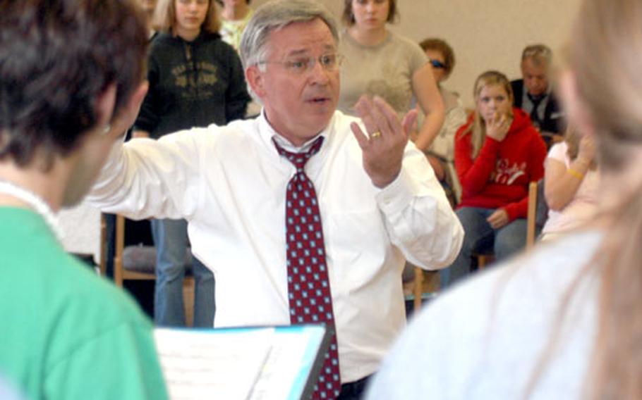 Craig Jessop, a guest conductor from the Mormon Tabernacle Choir in Salt Lake City, leads 80 Department of Defense Dependents Schools students Tuesday during a rehearsal of the Honors Music Festival choir in Germany.