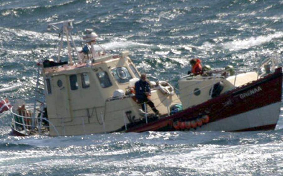 Danish crewmembers on a 45-foot fishing vessel await assistance Wednesday from rescue personnel assigned to the USS O’Bannon.