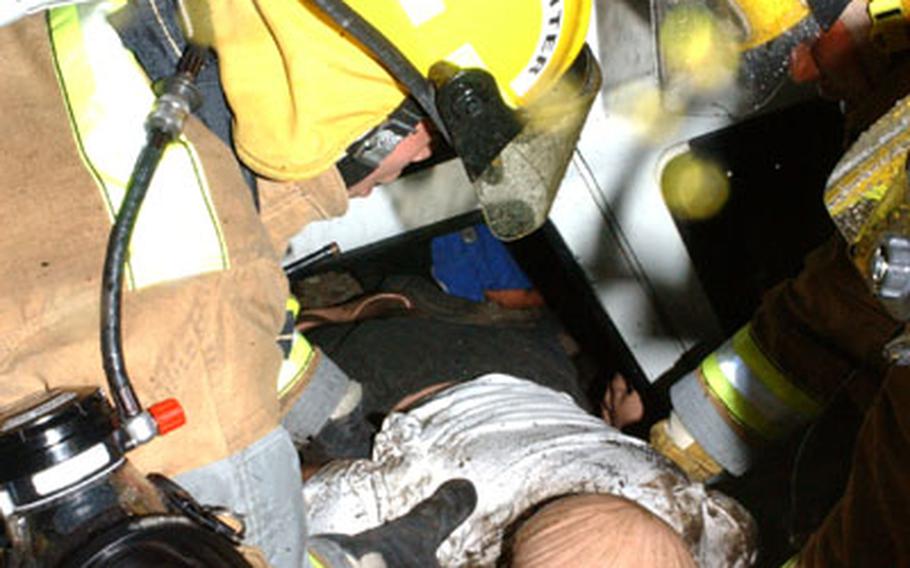 Camp Zama Fire and Emergency Services personnel rescue an injured "victim" buried underneath the fallen rubble of an exploded building during a post-wide anti-terrorism exercise Thursday at Camp Zama.