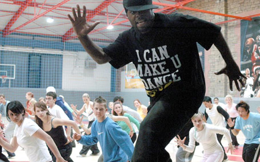 Choreographer Roland “Ro-Ro” Tabor leads a group of dancers through one of the routines he’s used with artists such as Usher, Aaliyah and Omarion on Thursday in Würzburg, Germany. To come up with his moves, Tabor said he doesn’t even try to come up with steps the first day he hears a piece of music — he memorizes the song first.