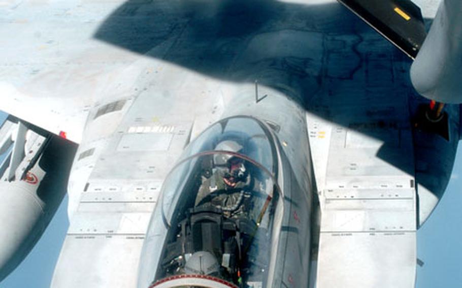 Maj. Brian Bergeron, in the rear seat, an F-15 pilot from the 2nd Fighter Squadron, Tyndall Air Force Base, Fla., flies in an F-15 from Japan Air Self-Defense Force, piloted by Maj. Tasumi Higuchi, during air-to-air refueling training.