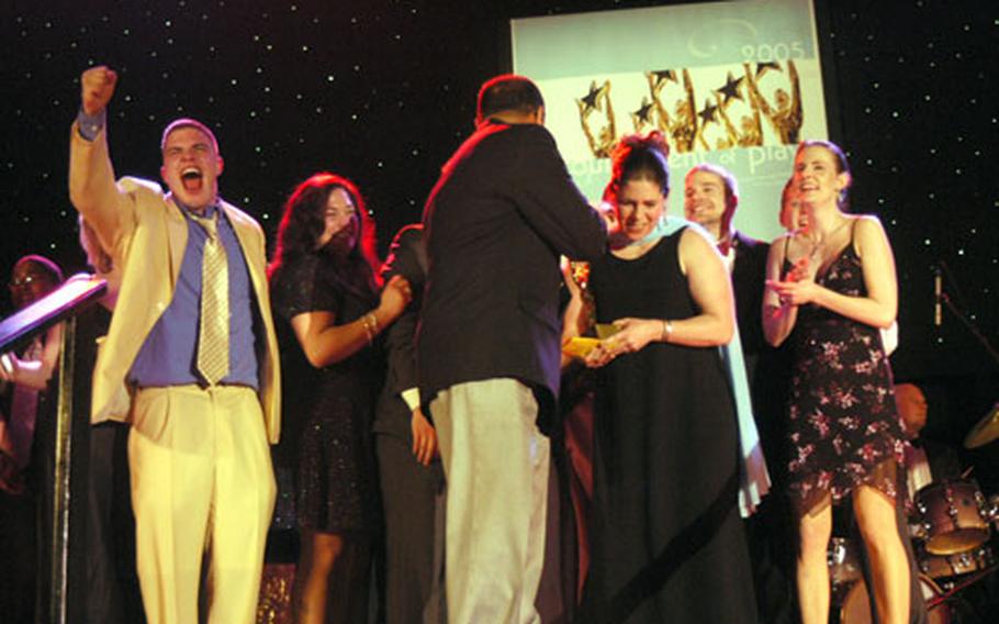 Members of the cast of Kaiserslautern’s “Godspell” celebrate onstage after winning the Topper for best musical Saturday at the 2005 Tournament of Plays in Heidelberg.