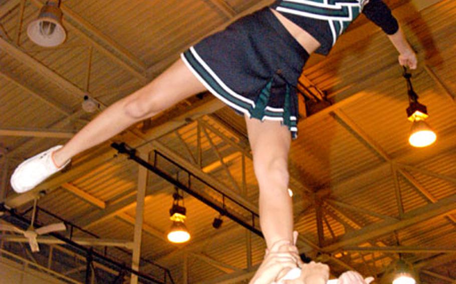 Aimee Hildenbrand, a sophomore at Taegu American School in South Korea, reaches for the rafters as the school’s Warriors Varsity Cheerleaders Squad demonstrates one of its stunts. The team took second place in the small school co-ed division at the National Cheerleading Association U.S. Championships in Daytona Beach, Fla., on April 10.