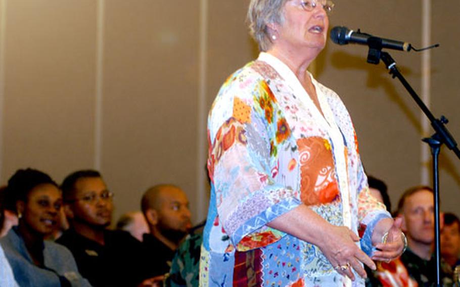 Sollars Elementary School teacher Carol Powell asks the GSA to stock recyclable paper products during a town hall meeting Wednesday night at Misawa Air Base, Japan. More than 200 people attended.