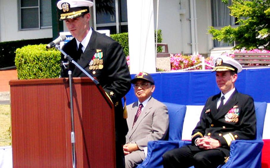 Capt. Tilghman D. Payne speaks after assuming command of Sasebo Naval Base, Japan, during a ceremony at base headquarters Thursday. At right is Rear Adm. Rick Ruehe, commander, U.S. Naval Forces Japan.