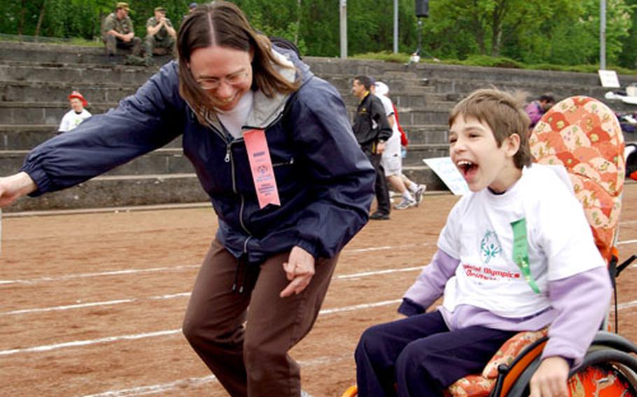 A volunteer cheers on a participant during the 2004 Special Olympics at Enkenbach-Alsenborn, near Kaiserslautern, Germany. The 2005 games will be held Wednesday.