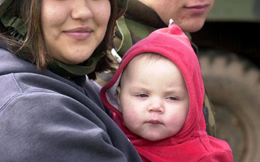 Pfc. Eric Peterson sits with his wife Catie, 19, and daughter Adalie, 9 months, during 1st Battalion 94th Field Artillery&#39;s family day Wednesday in Baumholder, Germany. Eric Peterson, an “ammo dog,” distributes rockets to Multiple Launch Rocket System crews. His family got to see the show, but not much of what he does, Peterson said. “I’ve still got that &#39;mystery man&#39; thing going on.”