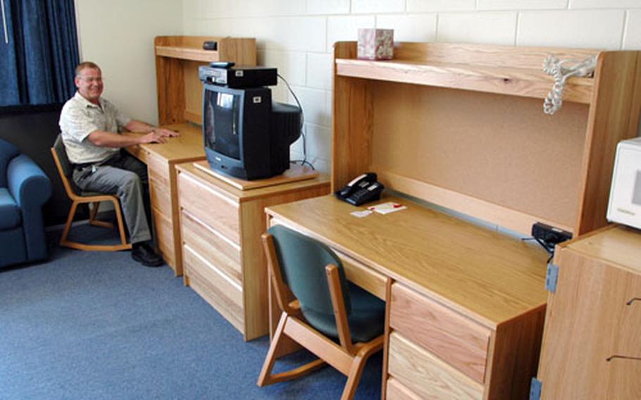 Kirby Franklin, an official with Marine Corps Air Station Iwakuni&#39;s Bachelor Housing Division, shows some of the new furnishings that were recently placed in one of the renovated barracks buildings as part of the Marine Corps&#39; Whole Room Program.