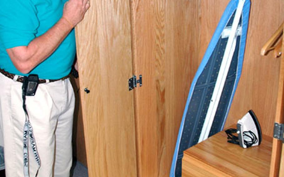 Bill Salter, director of Iwakuni&#39;s Bachelor Housing Division, shows some of the closet space in one of the renovated barracks rooms.