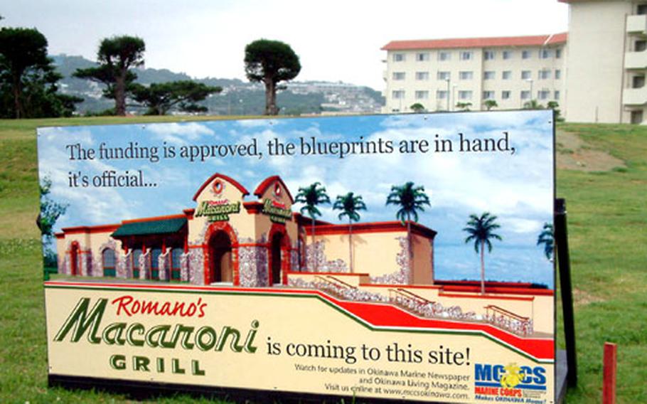 A small billboard announces the coming of Romano’s Macaroni Grill, an Italian restaurant, to Camp Foster on Okinawa. The MCCS project features, at 15,000 square feet, the largest Macaroni Grill in the chain.