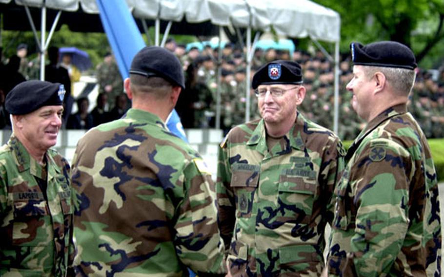 Welch, back to camera, prepares to pass the U.N. Command colors to Wheeler. At left is Gen. Leon LaPorte, U.S. Forces Korea commander; at right is Troop Command Sgt. Maj. James R. Boling.