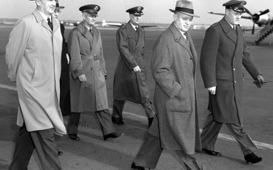 U.S. Senators Stuart Symington (D-Mo.), left, and Styles Bridges (R-N.H.) walk with leaders of U.S. forces in Europe after arriving at Rhein-Main in February, 1954.