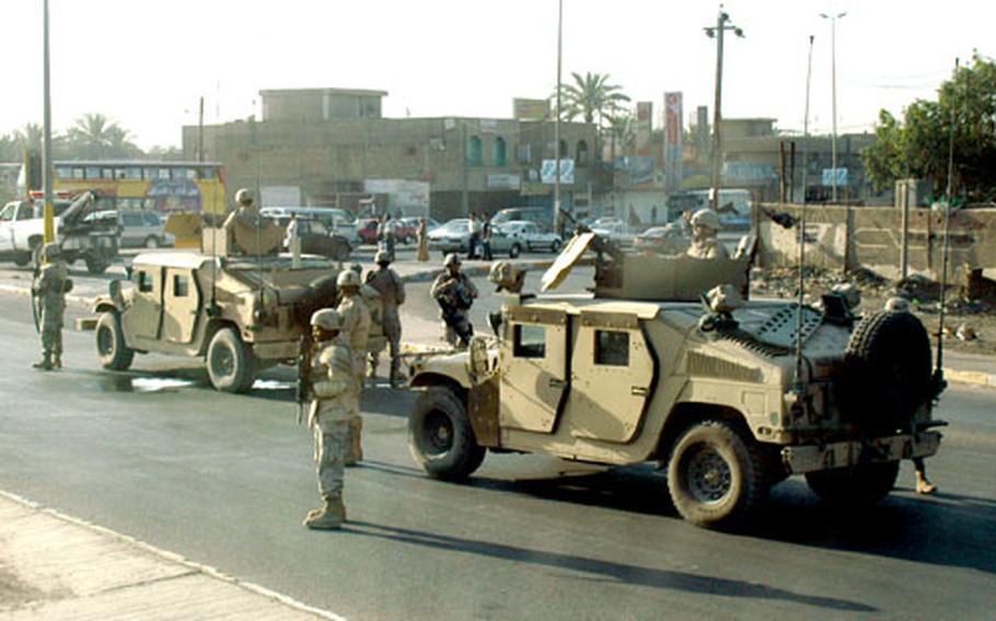 U.S. soldiers stop traffic in Iraq while waiting for a bomb squad to arrive and detonate three IEDs. The homemade bombs were discovered Thursday by a platoon with the 1088th Engineer Battalion.