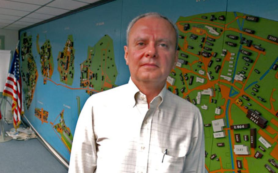 Uijongbu Garrison Department of Public Works director Ed Harris stands next to a three-dimensional map of U.S. bases in the Uijongbu area of South Korea.