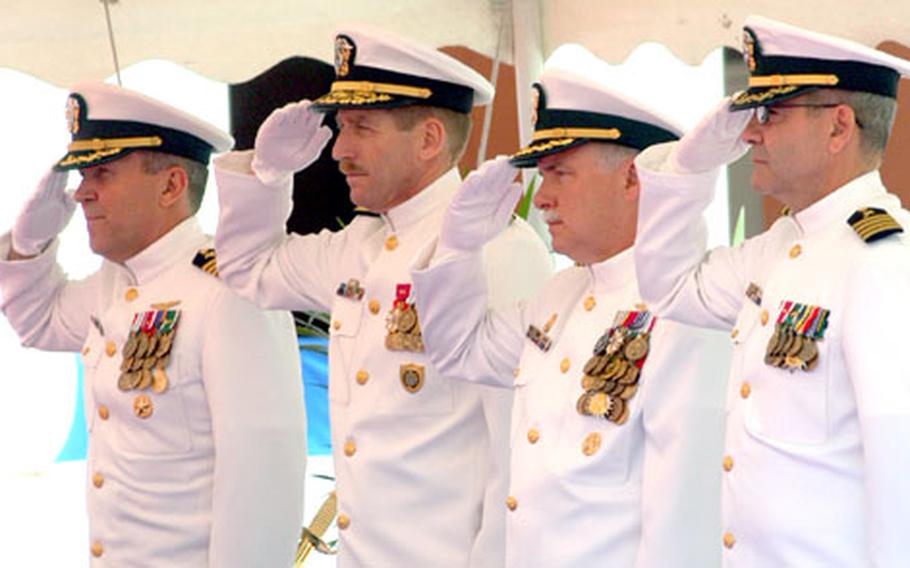 The official party salutes during the posting of the Italian and American flags during the Naval Support Activity Naples, Italy, change of command Friday when Capt. David Frederick turned over command to Capt. Gerald Hehe. From left: Hehe, Navy Region Europe commander Rear Adm. Noel Preston, Frederick and Chaplain (Capt.) Robert Malene.