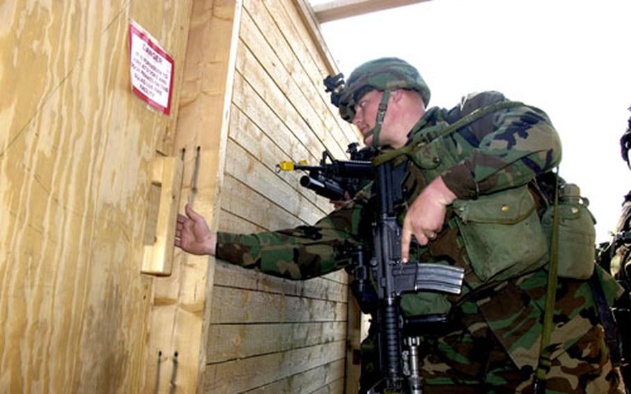 Erickson checks the door prior to going through it.