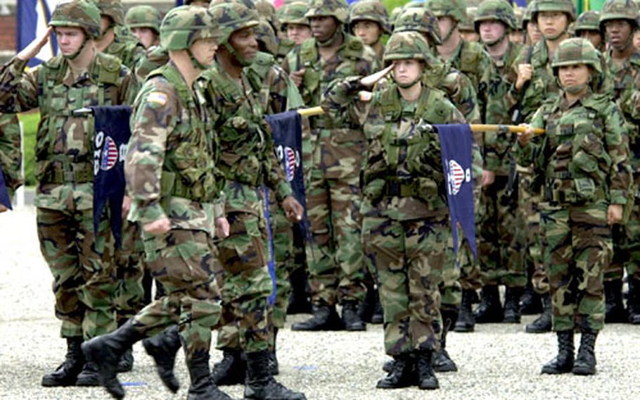 Col. Michael J. Harris, second from left, commander of the 8th Personnel Command, and his deputy commander, Col. Kevin M. Badger, inspect the troops during an inactivation ceremony Wednesday at Yongsan Garrison, South Korea.