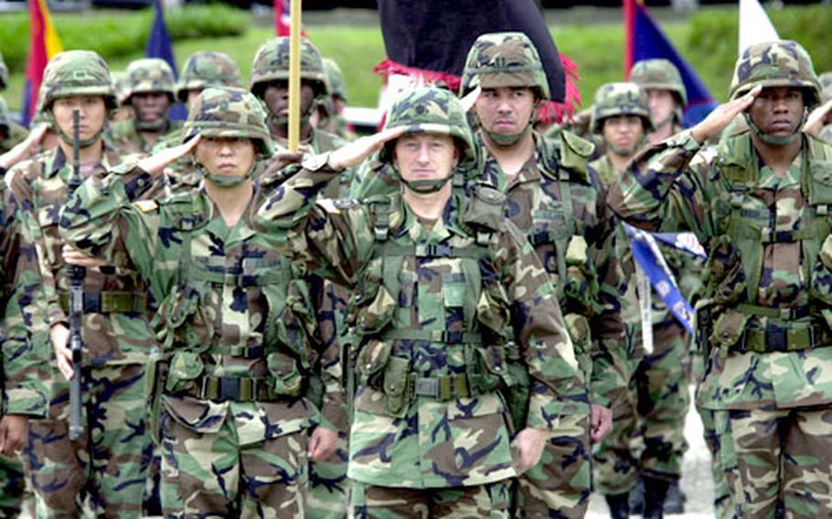 Members of the U.S. Army&#39;s 8th Personnel Command salute during the inactivation ceremony.