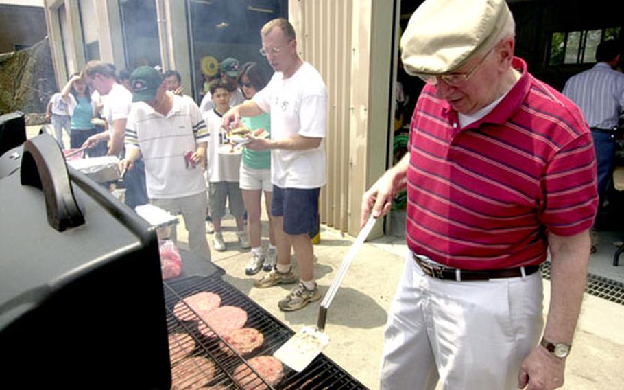 U.S. Army Corps of Engineers Far East District employee Frank Doyle cooks burgers on Friday during a picnic at the command’s headquarters in Seoul.