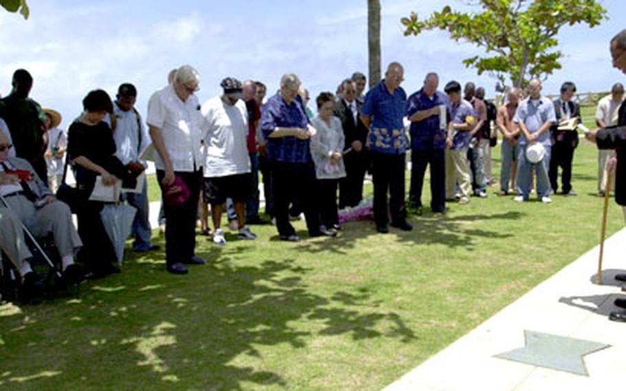 U.S. Navy Cmdr. Derek Ross, group chaplain for Task Force 76, says a prayer during a short ceremony Thursday in honor of the Americans killed during the Battle of Okinawa. The ceremony took place after a larger 60th anniversary event at Peace Prayer Park in Itoman.
