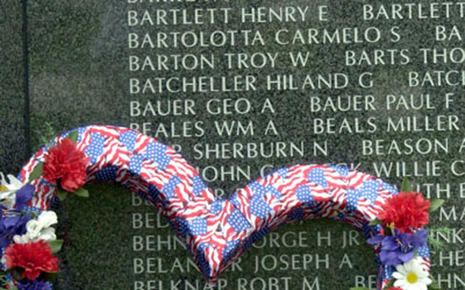 A wreath at the foot of one of the panels in Peace Prayer Park displaying the names of Americans killed during the Battle of Okinawa.