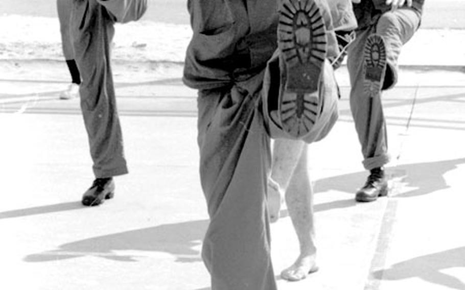 Sp4 Larry Dover of B Company, 1/12, 4th Infantry Division, takes part in morning exercises at the 6th Convalescent Center at Cam Ranh Bay, South Vietnam, in September, 1969.