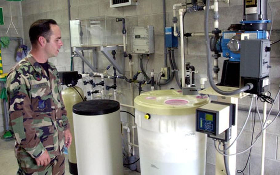 Airman Richard Thornton explains the fluoridation method used at a water station near Kadena Air Base’s Gate 2. The base stopped fluoridating water after it determined that the system design could not keep pace with water flow. A new system is expected to be ready in 2007.