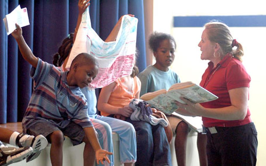 Sallyanne Marshall of the Giessen library puts on a skit with the help of some of the kids at "Stories in the Park."