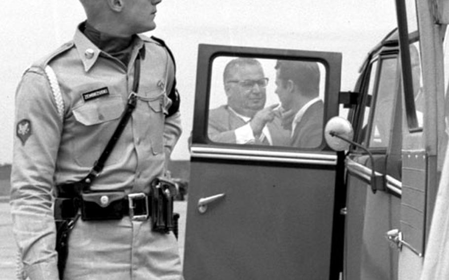 An MP stands guard as Audie Murphy gets ready for a scene. Murphy insisted on privacy, saying "you&#39;re not going to set me down and put on makeup in front of the whole damn Army."