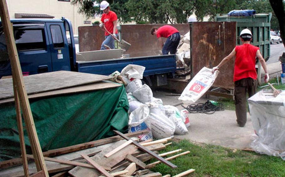 At Camp Henry in Taegu, South Korea, workers clear debris Friday during major repairs to two barracks on post.