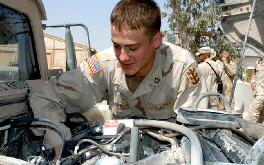 Pfc. Todd Jackson, Headquarters Support Company, 94th Engineer Combat Battalion (Heavy), performs maintenance on a Humvee on Sunday at Forward Operating Base Marez in Mosul, Iraq. The 94th is tasked with doing a lot of construction in the city of Mosul and outlying areas during its seven months in Iraq.