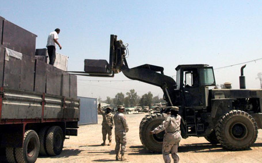 Soldiers from 94th Engineer Combat Battalion (Heavy) unload lockers from a truck Sunday at Forward Operating Base Marez.