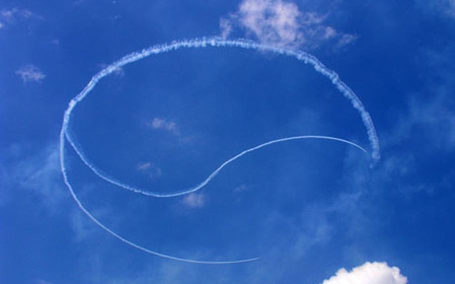 South Korea’s national emblem hangs in the skies above Osan Air Base after the South Korean air force Black Eagles flying team skywrote it during a precision flying demonstration. For more pictures, see our .