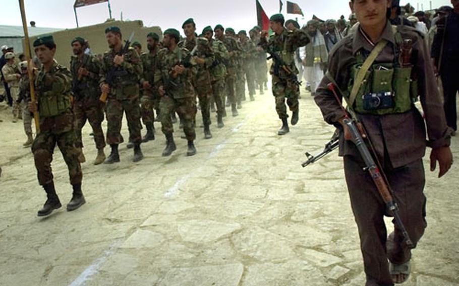 Afghan National Army soldiers march Saturday on the new cobblestone road in the town of Orgun-E.