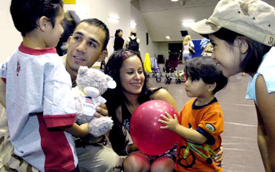 Staff Sgt. Johnny Salinas of 502nd Engineer Co. greets his family — wife Maria, daughter Fernanda (age 8), sons Joel (age 6) and Luis (age 18 months).