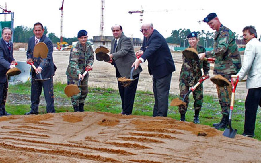 Officials at the Grafenwöhr, Germany, training area toss the first spadefuls of dirt at the construction site for the base’s new shopping center, a greatly expanded mall that will include a post exchange, commissary, food court and various smaller shops.