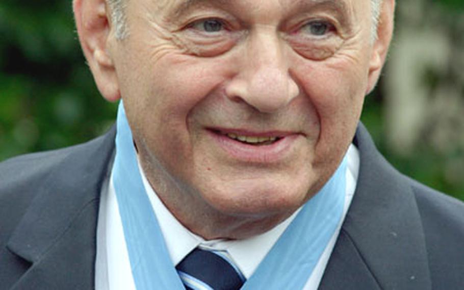 Tibor Rubin proudly wears his Medal of Honor as he talks to reporters outside the White House.