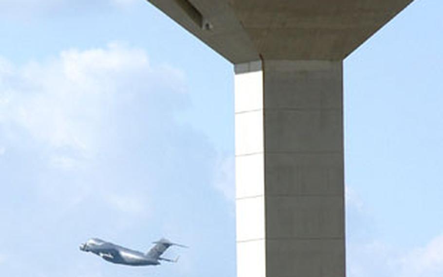 The last scheduled military flight from Rhein-Main Air Base, Germany, passes the Frankfurt International Airport control tower after take-off on Monday.