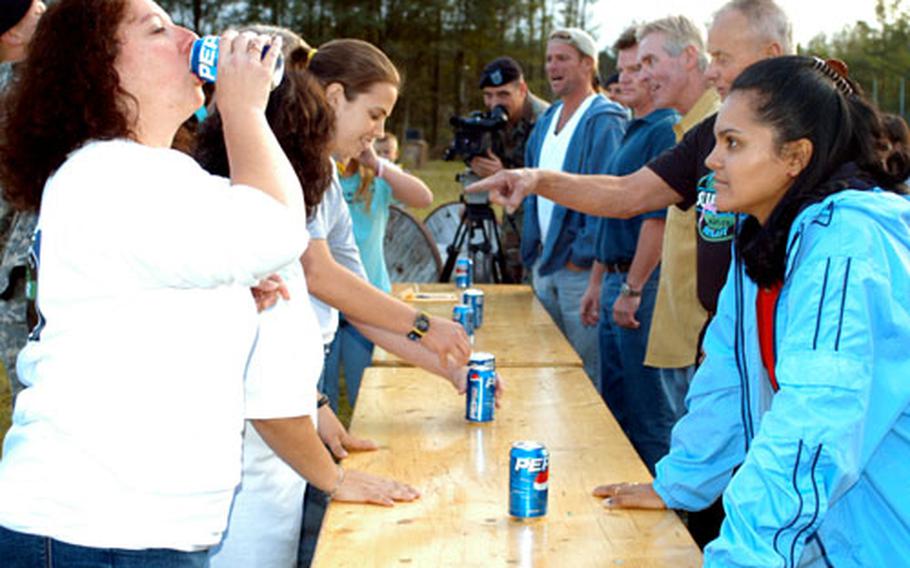 Stephanie Leeds, left foreground, guzzles a warm soda Wednesday as judge Sandra Diaz-Twine, right foreground, watches.