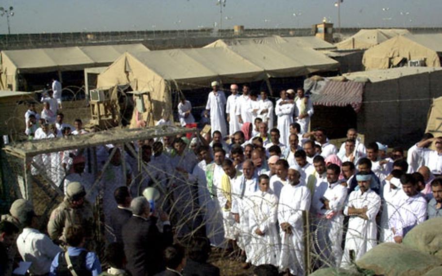 Prisoners listen to Iraqi government officials before their release from Abu Ghraib prison on Saturday.